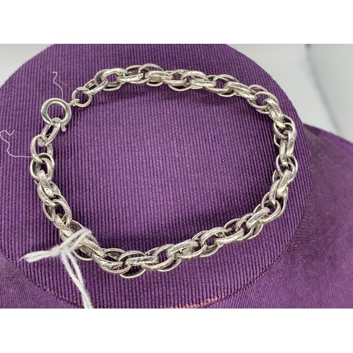 183 - A SILVER ENGRAVED DOUBLE LINK BRACELET 12.1 grms