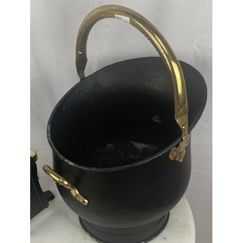 272 - A BLACK AND BRASS HELMET COAL SCUTTLE COMPANION SET AND FOLDDING FIRESCREEN