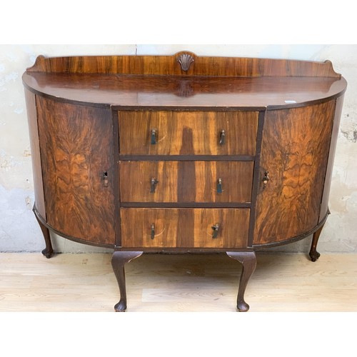 217 - A BOW FRONT WALNUT SIDEBOARD ON QUEEN ANNE LEG APPROX 55 x 19 x 40