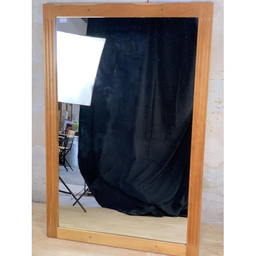 230 - AN OAK FRAMED MIRROR 36X54