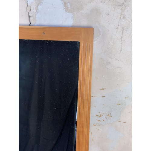 230 - AN OAK FRAMED MIRROR 36X54