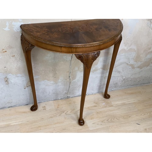 231 - A BURR WALNUT DEMI LUNE SIDE TABLE