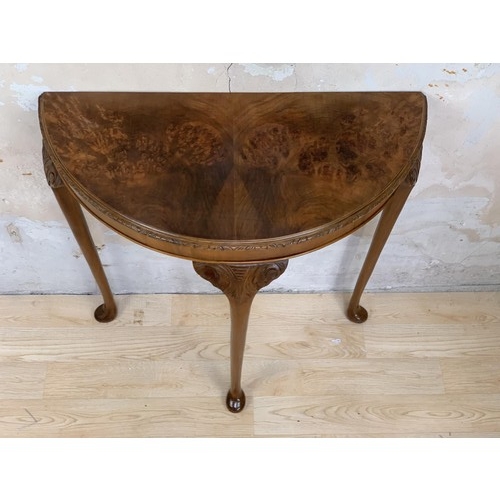 231 - A BURR WALNUT DEMI LUNE SIDE TABLE