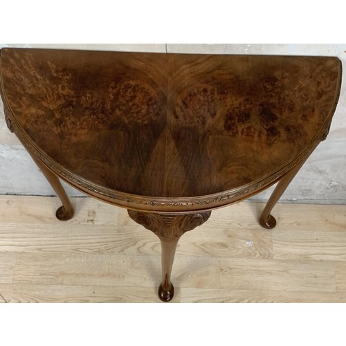 231 - A BURR WALNUT DEMI LUNE SIDE TABLE