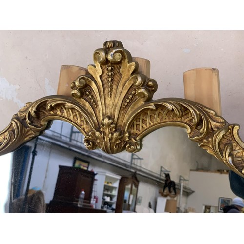 210A - A BEAUTIFUL SHAPED ORNATELY GILT FRAMED METAL MIRROR 41X26.5