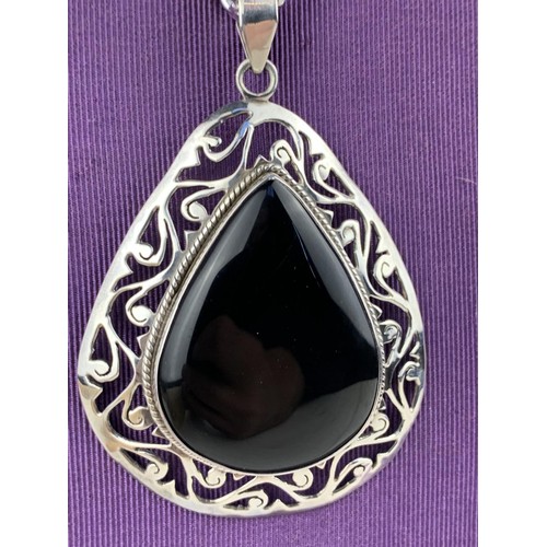 211 - A LARGE  HEAVY SILVER  & ONYX PENDANT ON LONG SILVER CHAIN 69.6grms