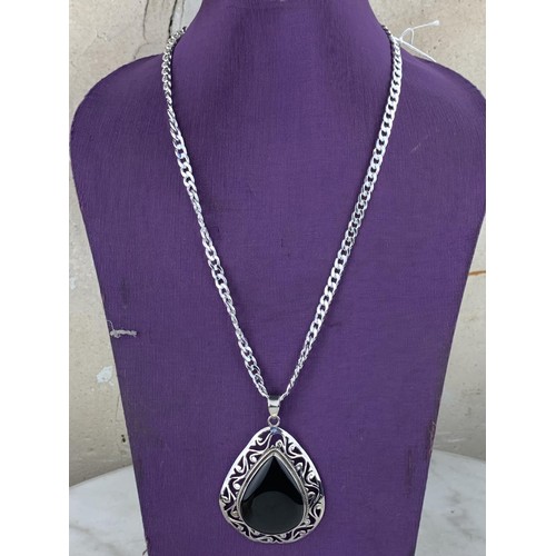 211 - A LARGE  HEAVY SILVER  & ONYX PENDANT ON LONG SILVER CHAIN 69.6grms