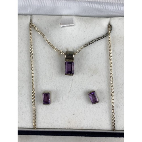 228 - A BOXED SILVER AND AMETHYST NECKLACE AND MATCHING EARRINGS