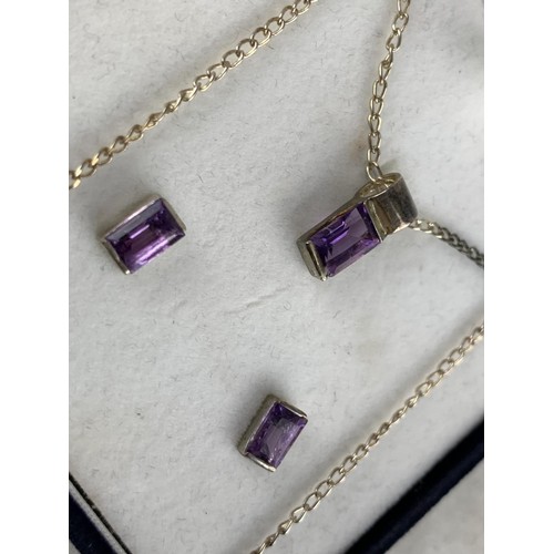 228 - A BOXED SILVER AND AMETHYST NECKLACE AND MATCHING EARRINGS