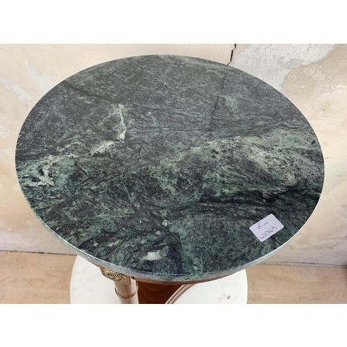 132 - A CIRCULAR MARBLE TOP TABLE