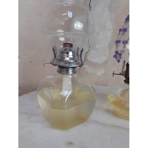 144 - 2 GLASS OIL LAMPS