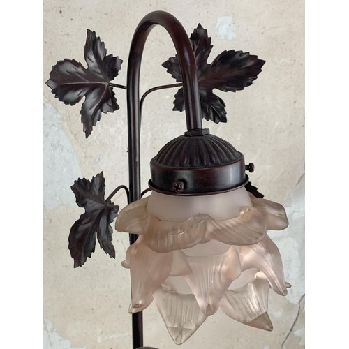 157 - A BRONZED FINISH FIGURENE LAMP WITH A TULIP SHADE