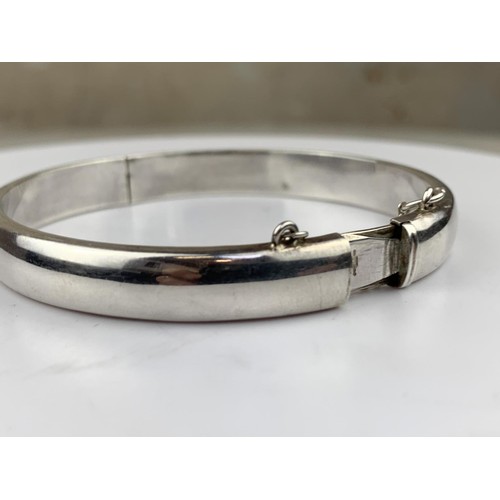 250 - A SILVER BANGLE WITH SAFETY CHAIN