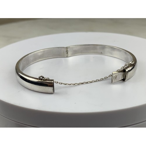 250 - A SILVER BANGLE WITH SAFETY CHAIN