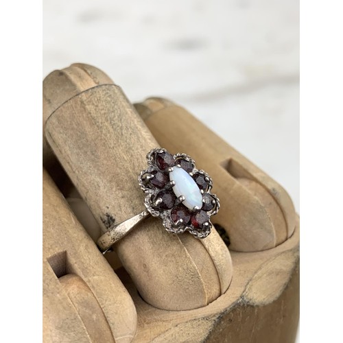 256 - A SILVER GARNET AND OPAL RING