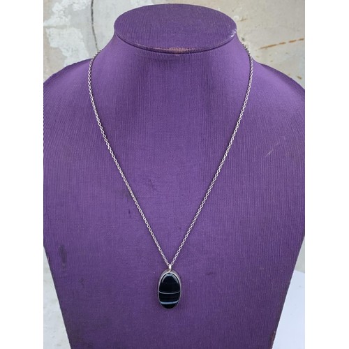 264 - A LARGE DESIGNER STYLE PENDANT ON LONG SILVER CHAIN