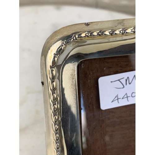 276 - A WOODEN BACK SILVER PHOTO FRAME