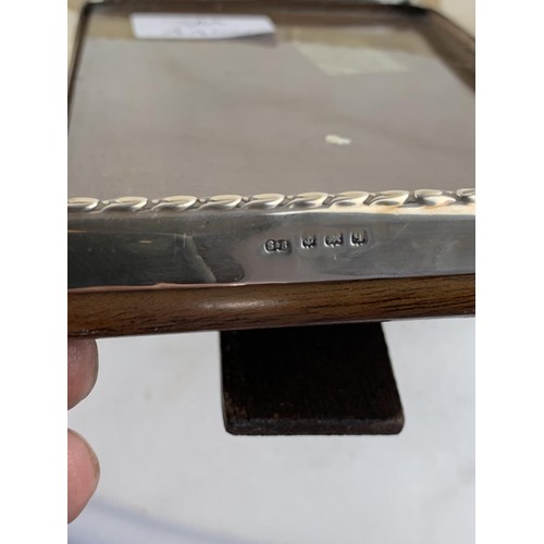 276 - A WOODEN BACK SILVER PHOTO FRAME