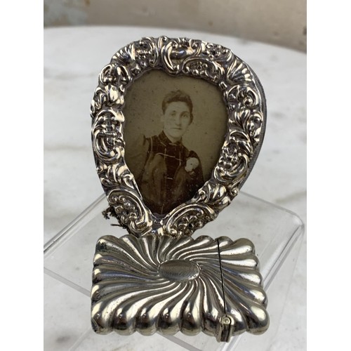 286 - A SILVER HEART PHOTO FRAME AND A VESTA CASE