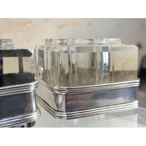 48 - A GLASS INKWELL WITH A WHITE METAL TRIM