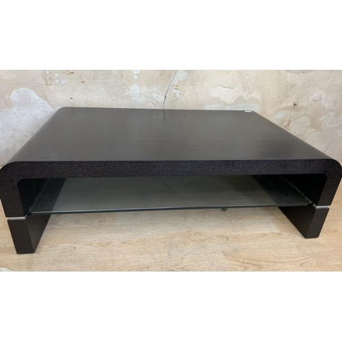 182 - AN EBONY/GLASS COFFEE TABLE 45x28x14