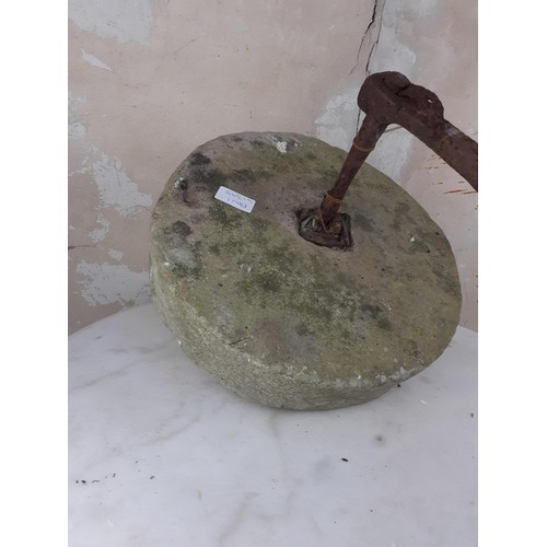 135 - A MILL STONE WITH METAL HANDLE