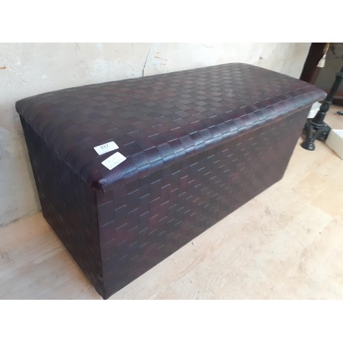 317 - A LEATHER OTTOMAN