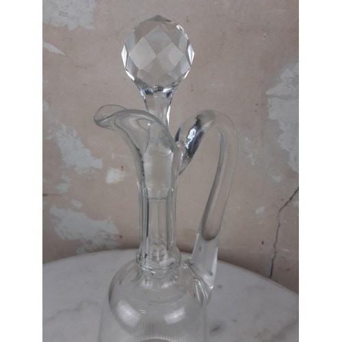 369 - A CUT GLASS EWER WITH STOPPER