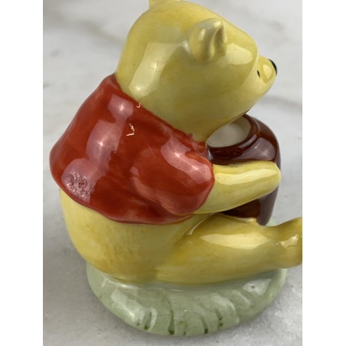 453 - A ROYAL DOULTON FIGURE WINNIE THE POOH AND THE HONEY POT