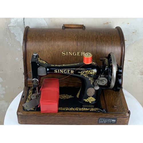 544 - AN OLD CASED (WITH KEY) SINGER HAND SEWING MACHINE PWO