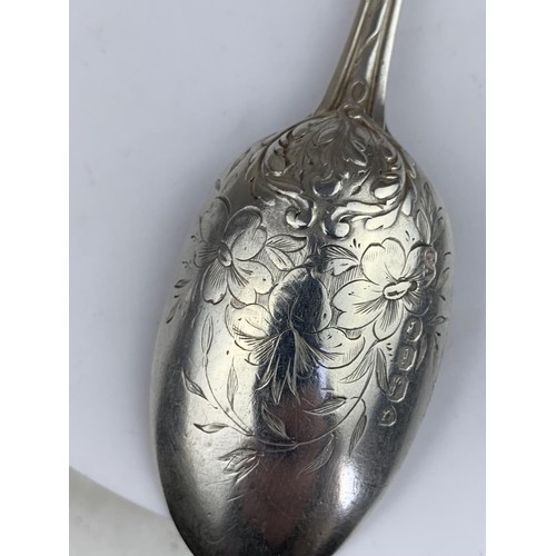 565 - A LONDON SILVER SPOON HEAVILY EMBOSSED WITH FLORAL PATTERN