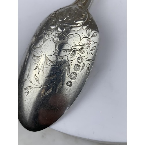 565 - A LONDON SILVER SPOON HEAVILY EMBOSSED WITH FLORAL PATTERN