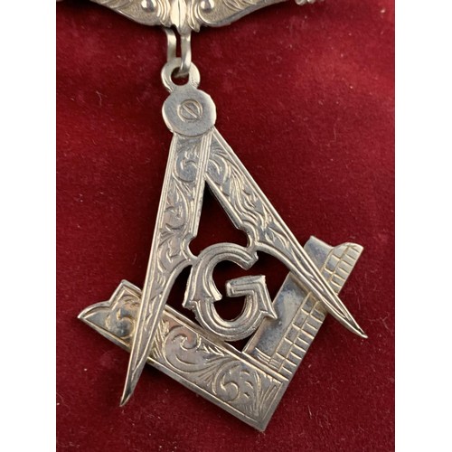 584 - A SILVER MASONIC MEDAL IN A POUCH