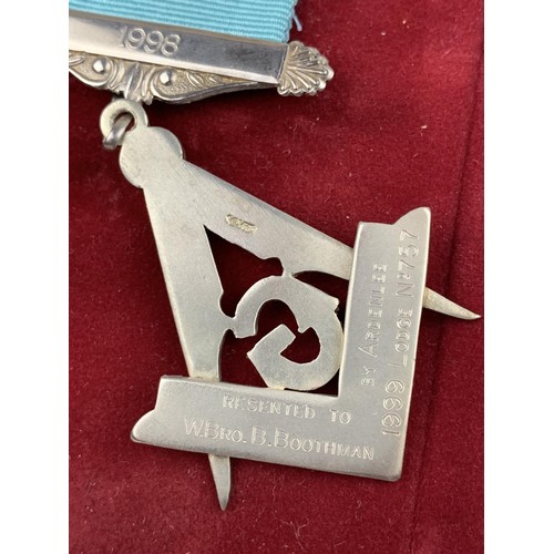 584 - A SILVER MASONIC MEDAL IN A POUCH