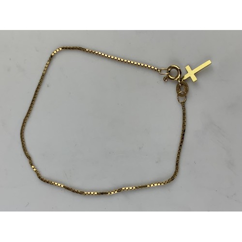 587 - A 9ct GOLD WRIST CHAIN SET WITH 9ct GOLD CROSS