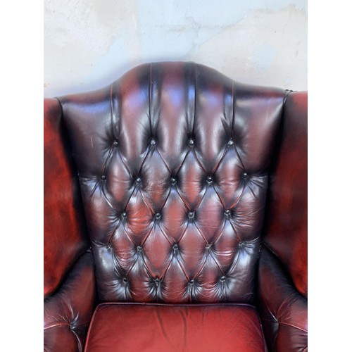 611 - PAIR OXBLOOD BUTTONED WINGBACK ARMCHAIRS