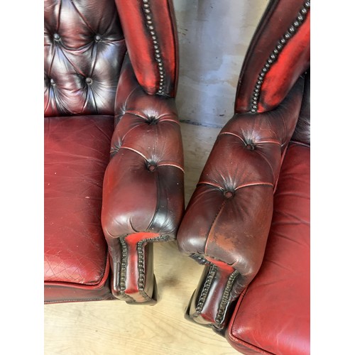 611 - PAIR OXBLOOD BUTTONED WINGBACK ARMCHAIRS