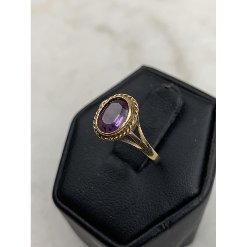 594 - AN ORNATE 9CT AMETHYST RING