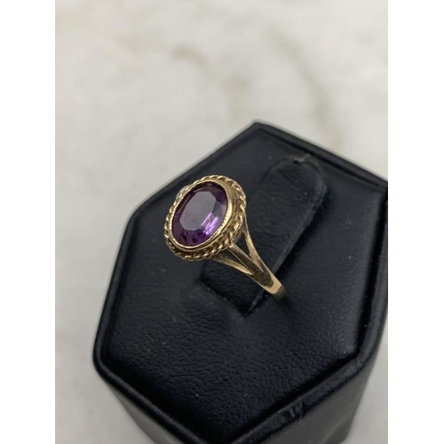 594 - AN ORNATE 9CT AMETHYST RING