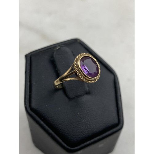 594 - AN ORNATE 9CT AMETHYST RING