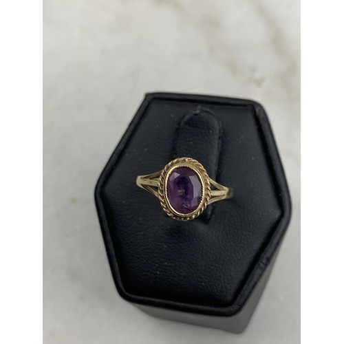 594 - AN ORNATE 9CT AMETHYST RING