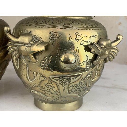 652 - A PAIR OF ORIENTAL HEAVY BRASS VASE EMBOSSED WITH DRAGONS 9.25