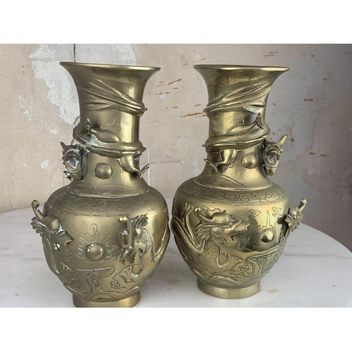 652 - A PAIR OF ORIENTAL HEAVY BRASS VASE EMBOSSED WITH DRAGONS 9.25