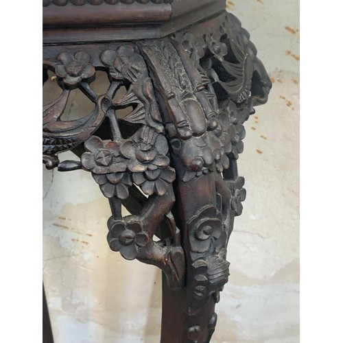 654 - HEAVILY CARVED MARBLE TOPPED ORIENTAL PLANTSTAND 3ft