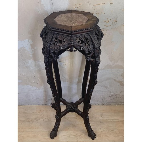 654 - HEAVILY CARVED MARBLE TOPPED ORIENTAL PLANTSTAND 3ft