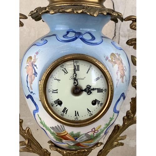 607 - A HEAVY BRASS HAND PAINTED CLOCK