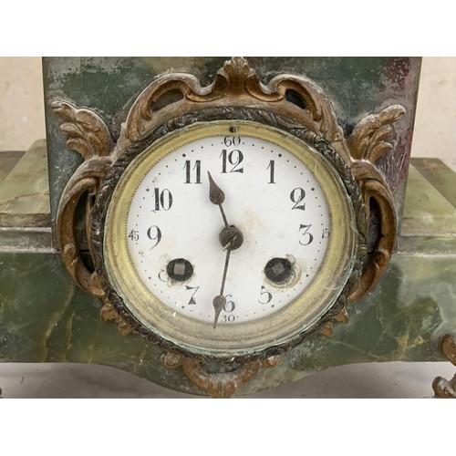 130 - A VICTORIAN GREEN MARBLE BASE CLOCK WITH SPELTER FIGURE 24