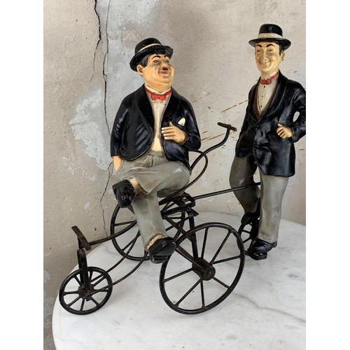 73 - LAUREL & HARDY FIGURINES ON A TRICYCLE 22 X 18