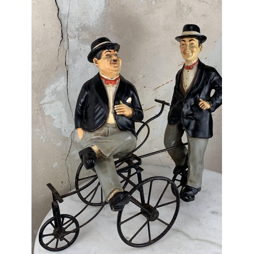 73 - LAUREL & HARDY FIGURINES ON A TRICYCLE 22 X 18