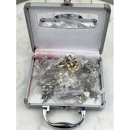 116 - A HARD CASE CONTAINING A LARGE AMOUNT OF WHITE METAL FOBS UNTESTED